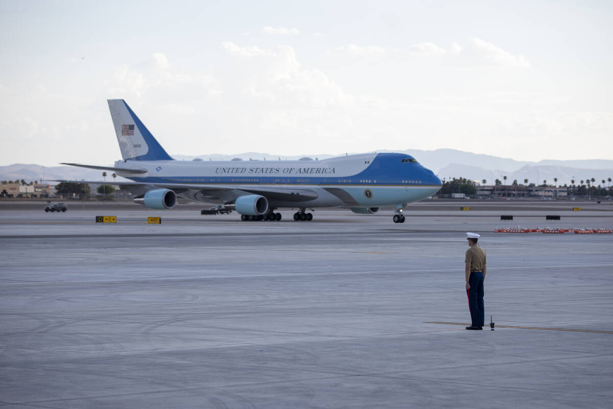 A U.S. Marine waits for the arrival of Air Force One at Harry Reid International Airport, Monda ...