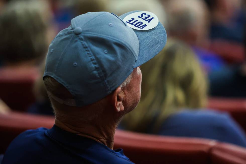 A supporter wears a sticker on their hat to express approval of a new Church of Jesus Christ of ...