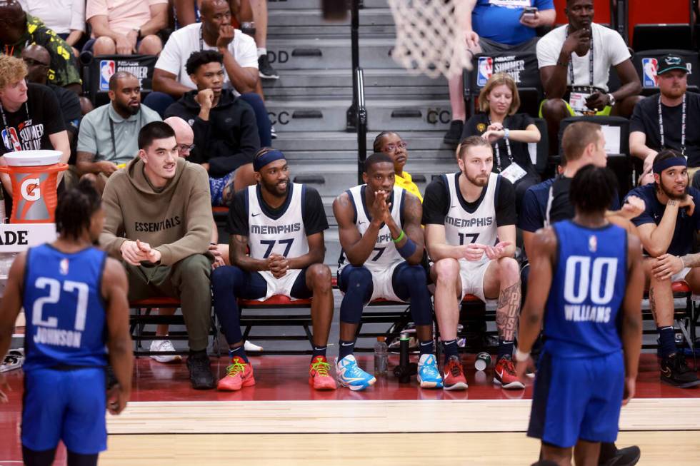 Memphis center Zach Edey, left, watches his team take on the Dallas Mavericks during an NBA Sum ...