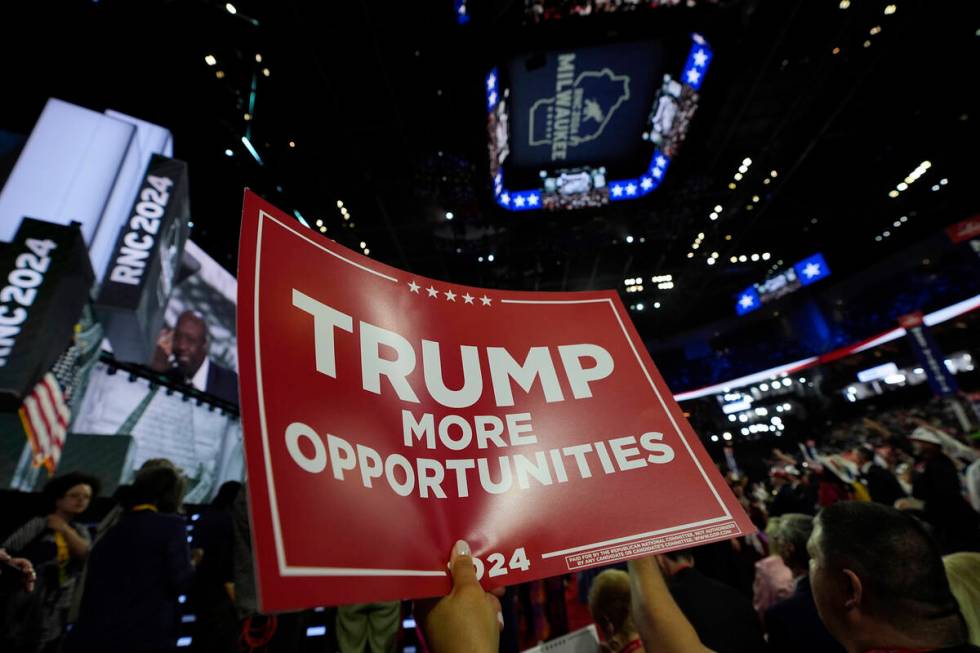 A delegate holds up a sign during the Republican National Convention Monday, July 15, 2024, in ...