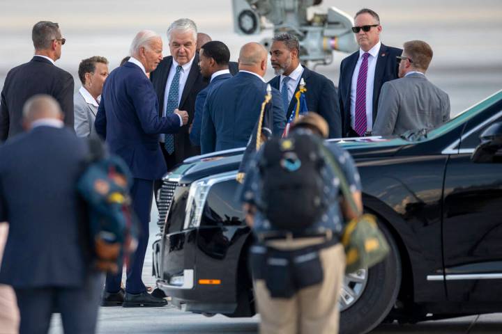 President Joe Biden talks to, from left, former Governor Steve Sisolak, Clark County Commission ...