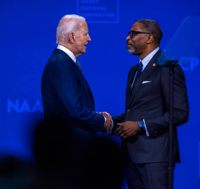 President Joe Biden greets NAACP President and CEO Derrick Johnson as he takes the stage to spe ...