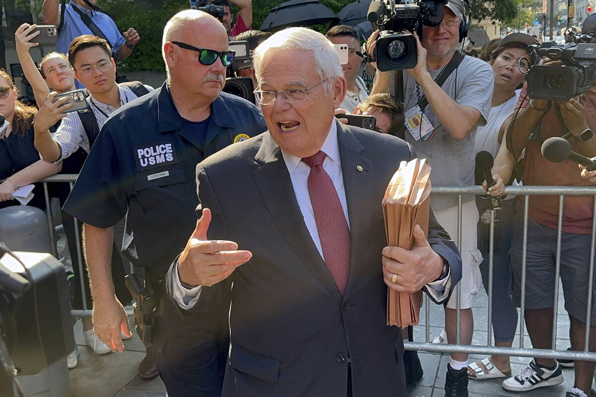 United States Sen. Bob Menendez, D-N.J., foreground, leaves federal court following the day's p ...