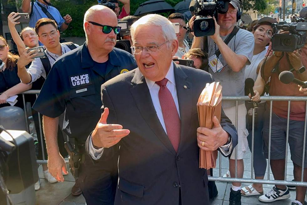United States Sen. Bob Menendez, D-N.J., foreground, leaves federal court following the day's p ...