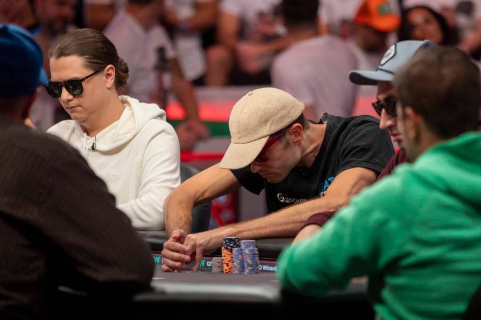 Joe Serock checks his cards during the final table of the World Series of Poker Main Event at H ...