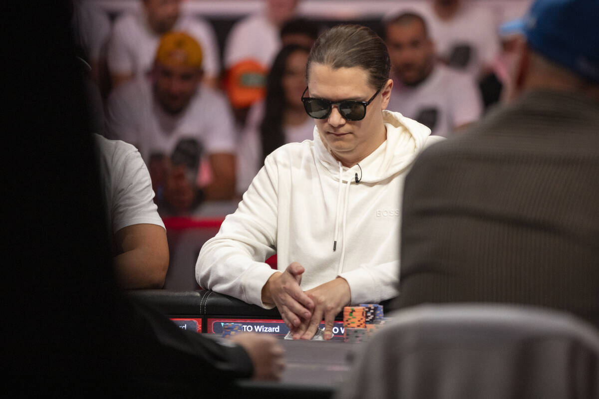 Niklas Astedt checks his cards during the final table of the World Series of Poker Main Event a ...