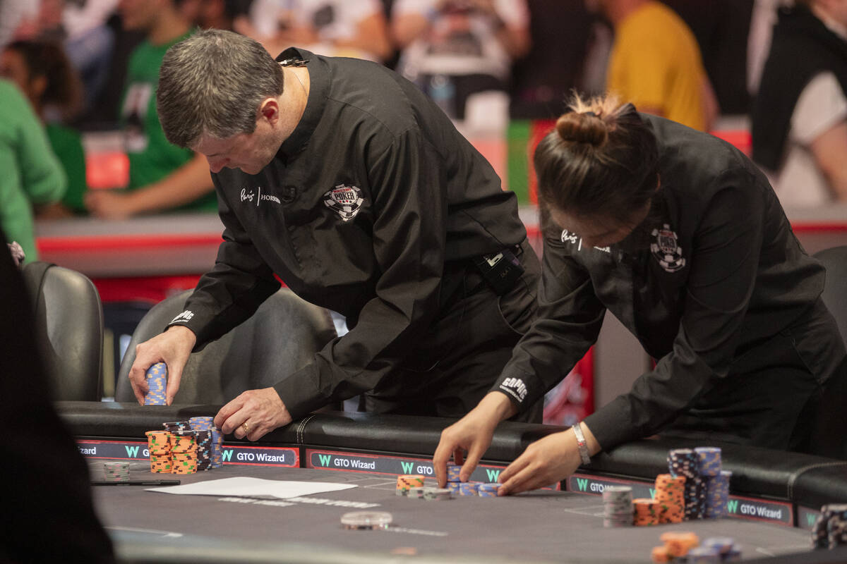 Dealers check the chip count of each competitor during a break in the final table of the World ...
