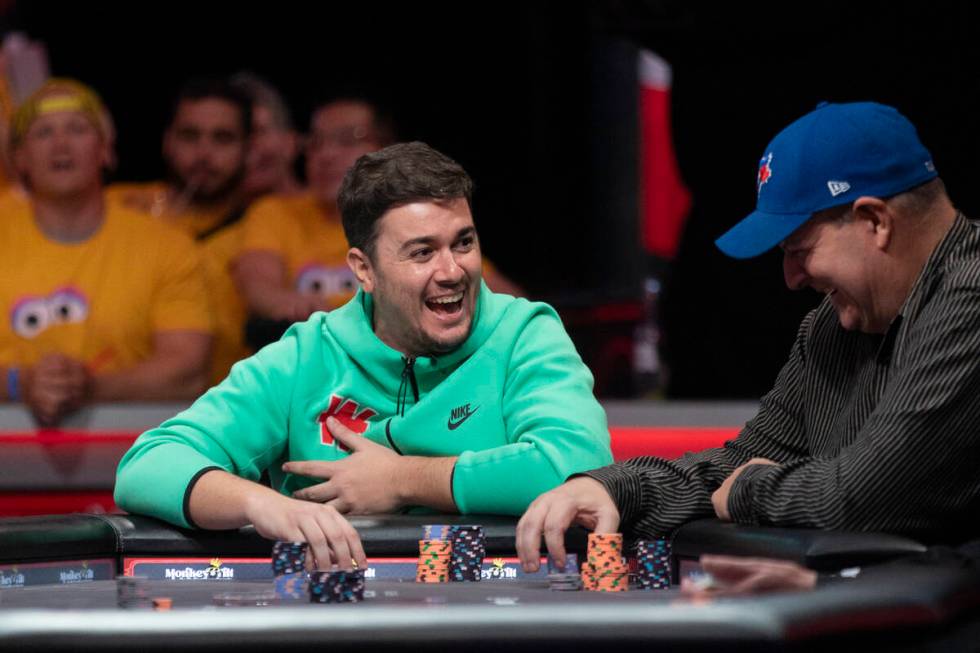Andres Gonzalez, left, and Jason Sagle, right, laugh while competing in the final table of the ...