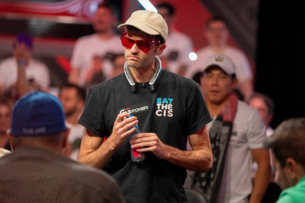Joe Serock looks at his losing hand that knocked him out of competition during the final table ...