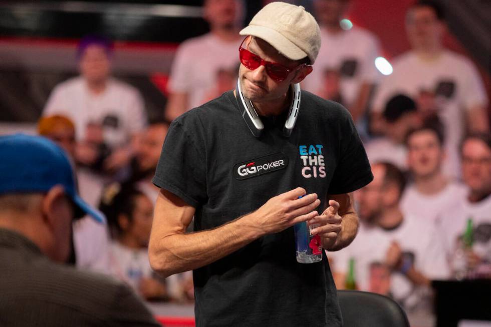 Joe Serock looks at his losing hand that knocked him out of competition during the final table ...