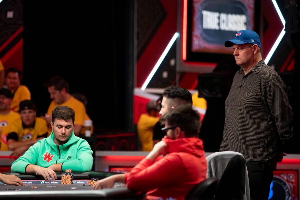 Jason Sagle, right, watch hands play in the final table of the World Series of Poker Main Event ...