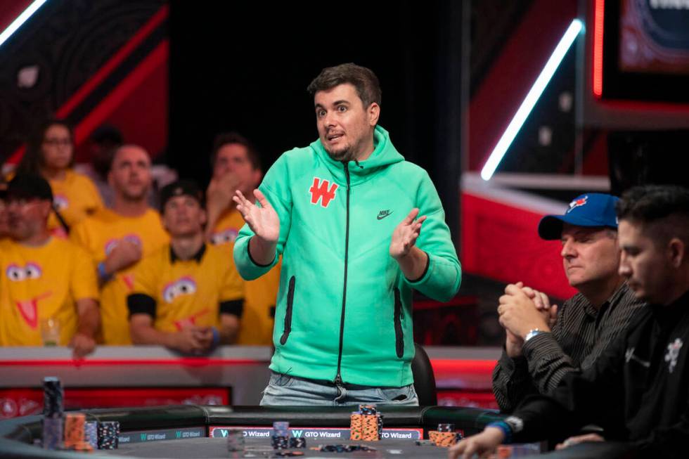 Andres Gonzalez talks to family and friends in the crowd while competing in the final table of ...