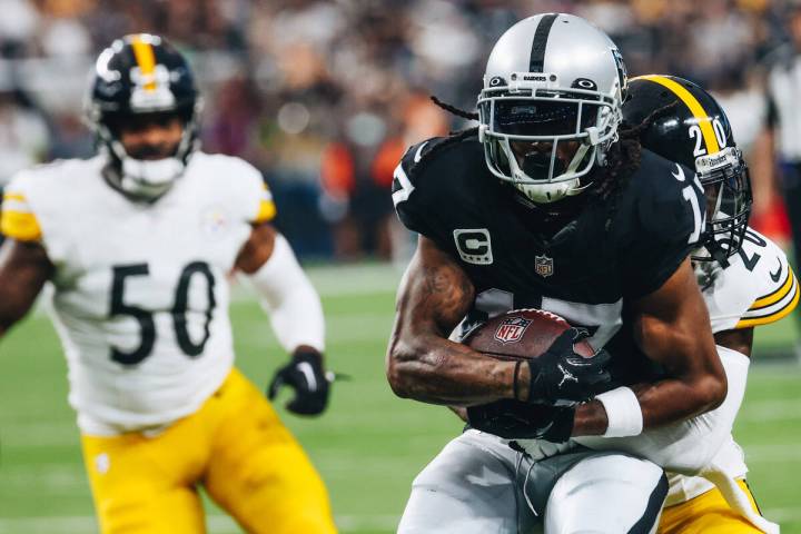 Raiders wide receiver Davante Adams (17) holds onto the ball after a successful catch as Pittsb ...