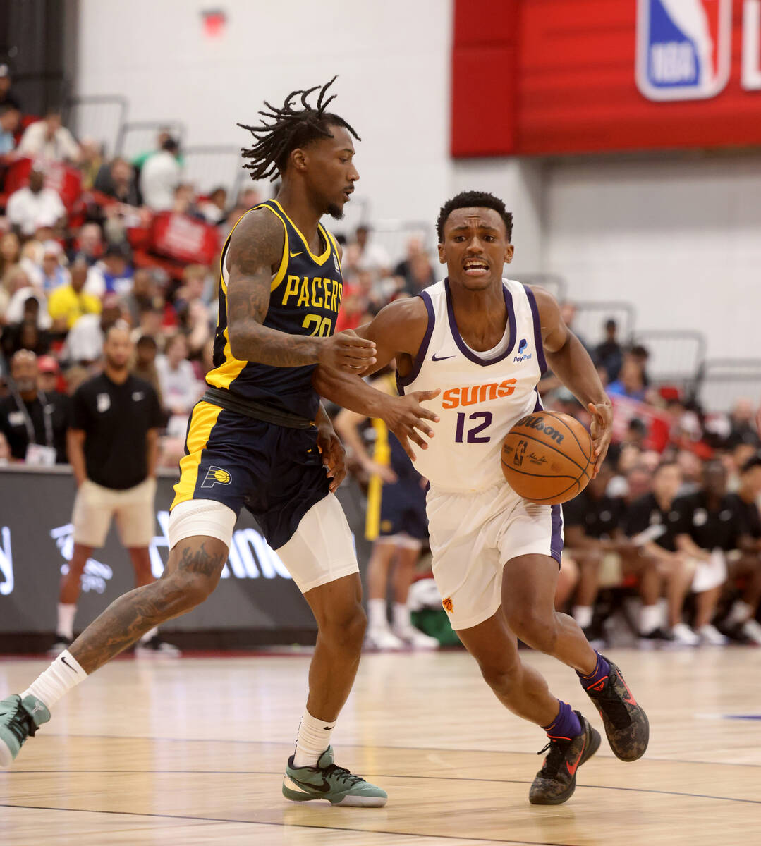 Phoenix Suns guard Tyson Walker (12) drives past Indiana Pacers guard Quenton Jackson (29) in t ...