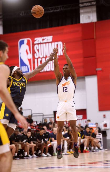 Phoenix Suns guard Tyson Walker (12) shoots over Indiana Pacers forward Jarace Walker (5) durin ...