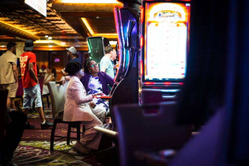 People play slot machines during the final night of operations and gaming at The Mirage on Tues ...