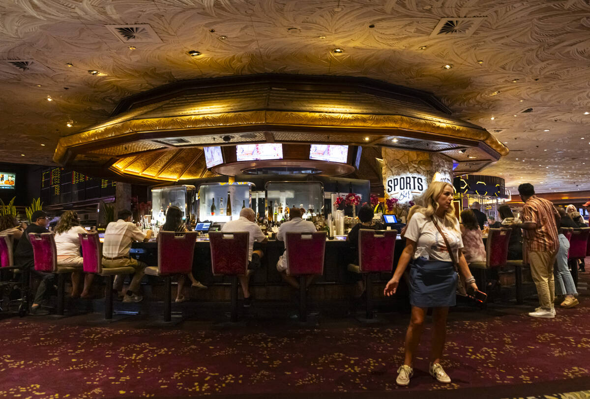 A woman stands by a casino bar during the final night of operations and gaming at The Mirage on ...