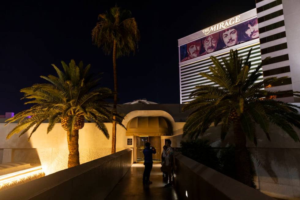 People take photos outside during the final night of operations and gaming at The Mirage in the ...