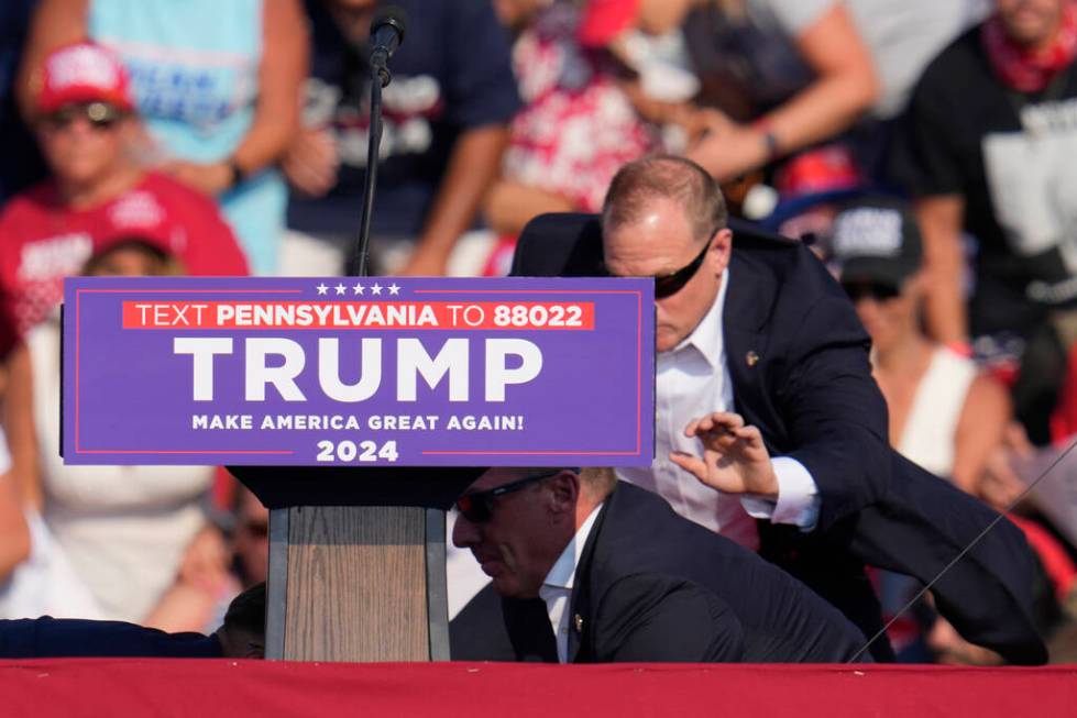 U.S. Secret Service agents surround Republican presidential candidate former President Donald T ...