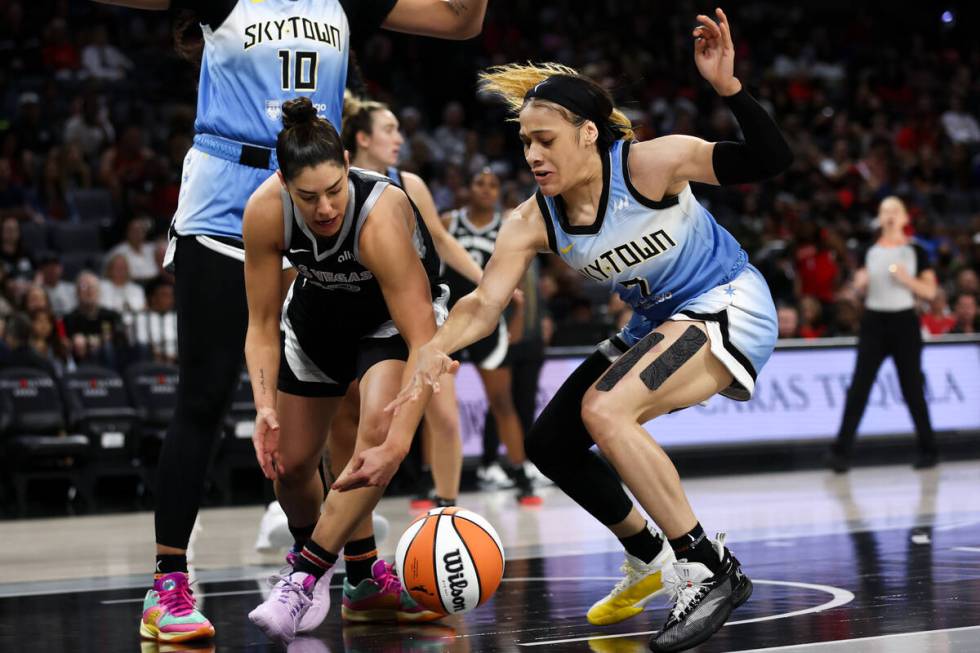 Chicago Sky guard Chennedy Carter, right, steals the ball from Las Vegas Aces guard Kelsey Plum ...