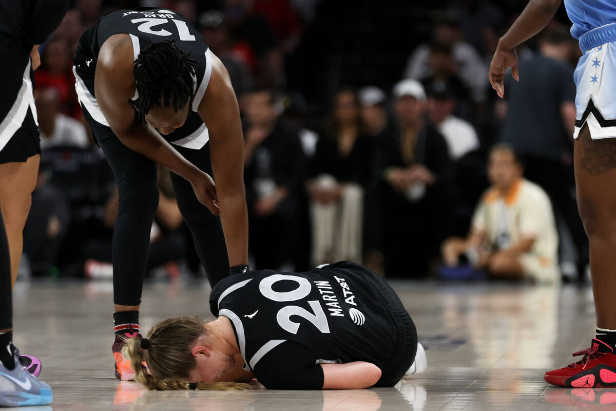 Las Vegas Aces guard Kate Martin (20) lies on the court with an injury during the first half of ...