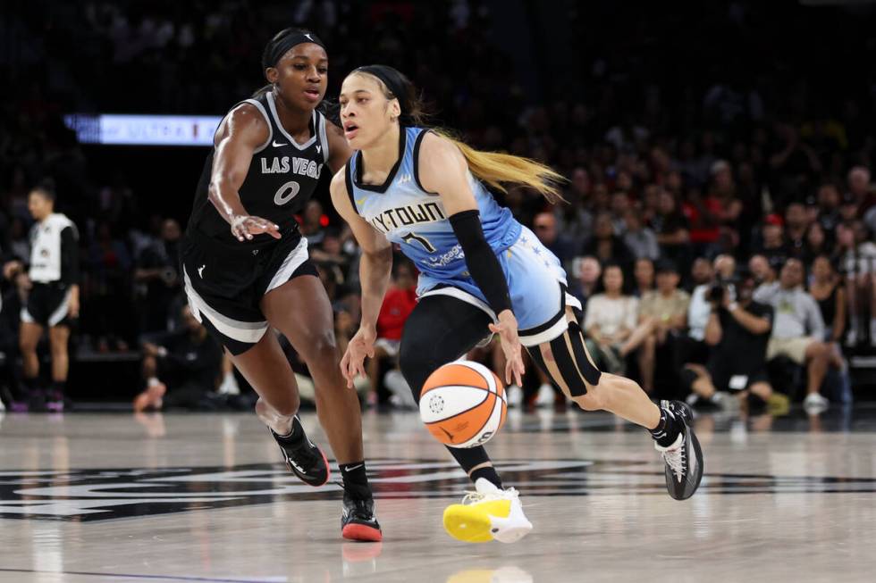Chicago Sky guard Chennedy Carter (7) dribbles up the court against Las Vegas Aces guard Jackie ...