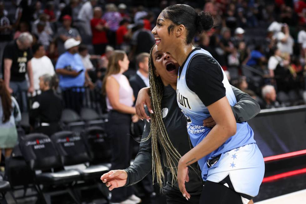 Chicago Sky head coach Teresa Weatherspoon, left, and forward Angel Reese embrace after winning ...