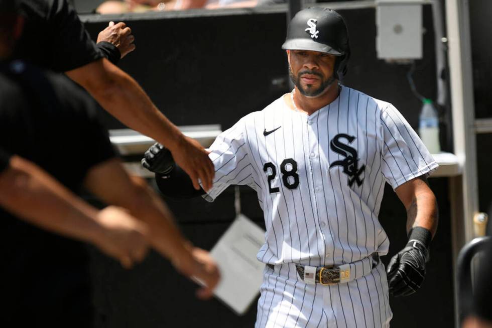 Chicago White Sox's Tommy Pham (28) celebrates with teammates in the dugout after scoring durin ...