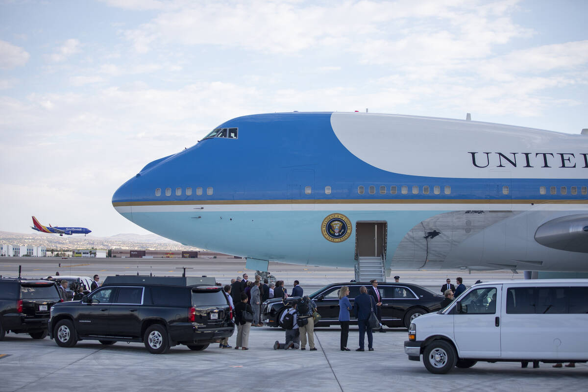 A motorcade waits outside Air Force One at Harry Reid International Airport, Monday, July 15, 2 ...