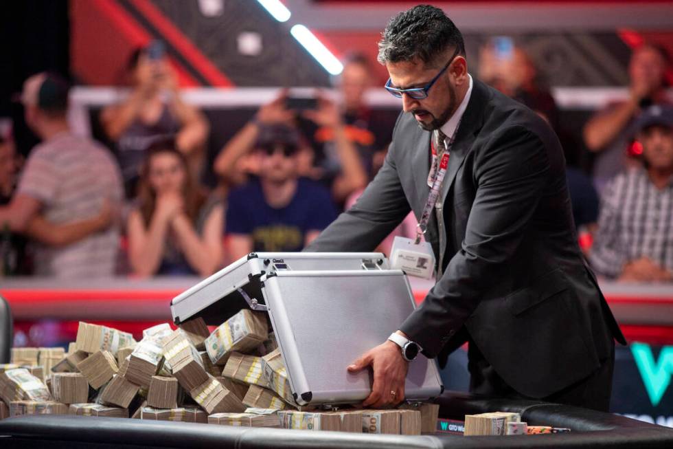 The cash prize is dumped out of briefcases onto the final table of the World Series of Poker Ma ...