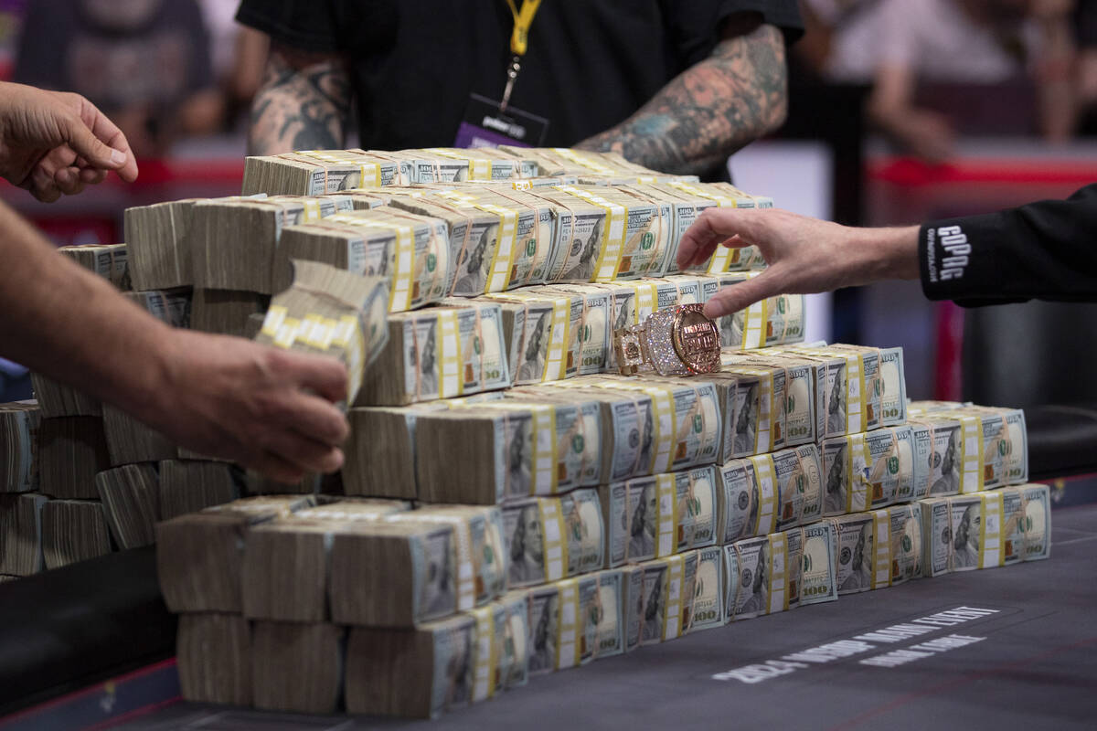 Crew members set up the cash prize and bracelet on the final table of the World Series of Poker ...