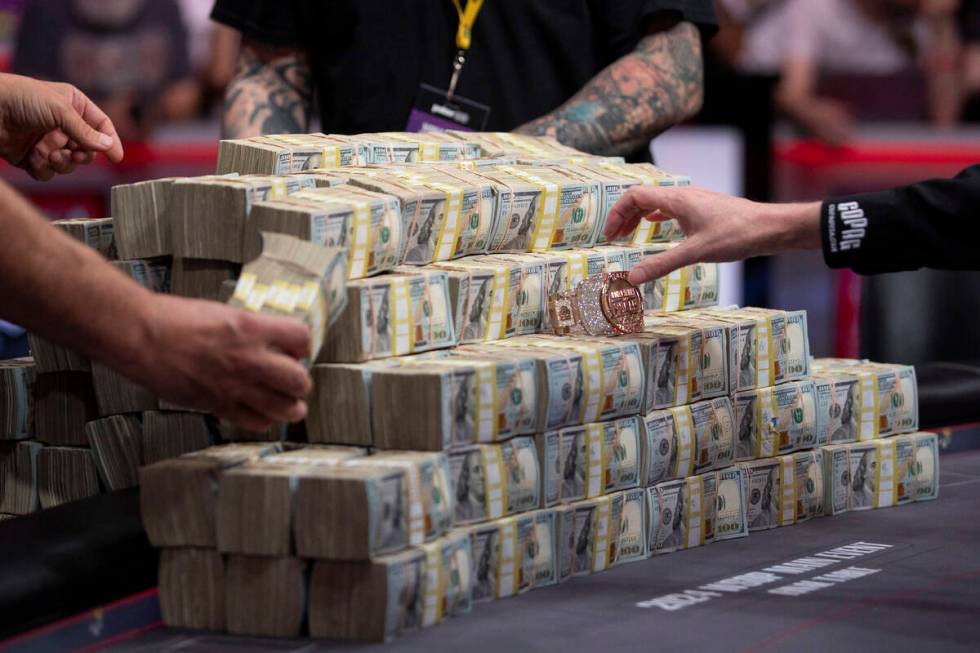 Crew members set up the cash prize and bracelet on the final table of the World Series of Poker ...