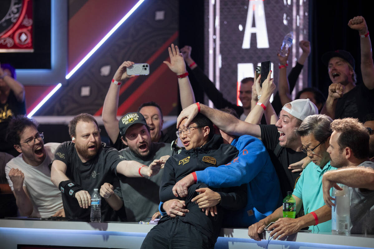 Jonathan Tamayo, center, is grabbed by family and friends after winning the final table of the ...