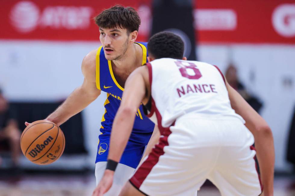 Golden State Warriors center/forward Roman Sorkin dribbles the ball as he looks to pass it to a ...