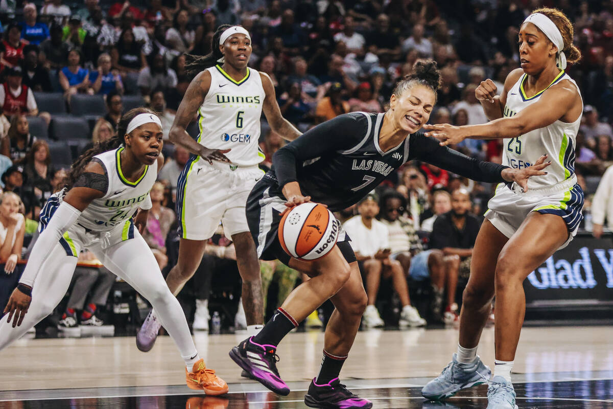 Aces forward Alysha Clark (7) dribbles the ball away from Dallas Wings defense during a WNBA ba ...