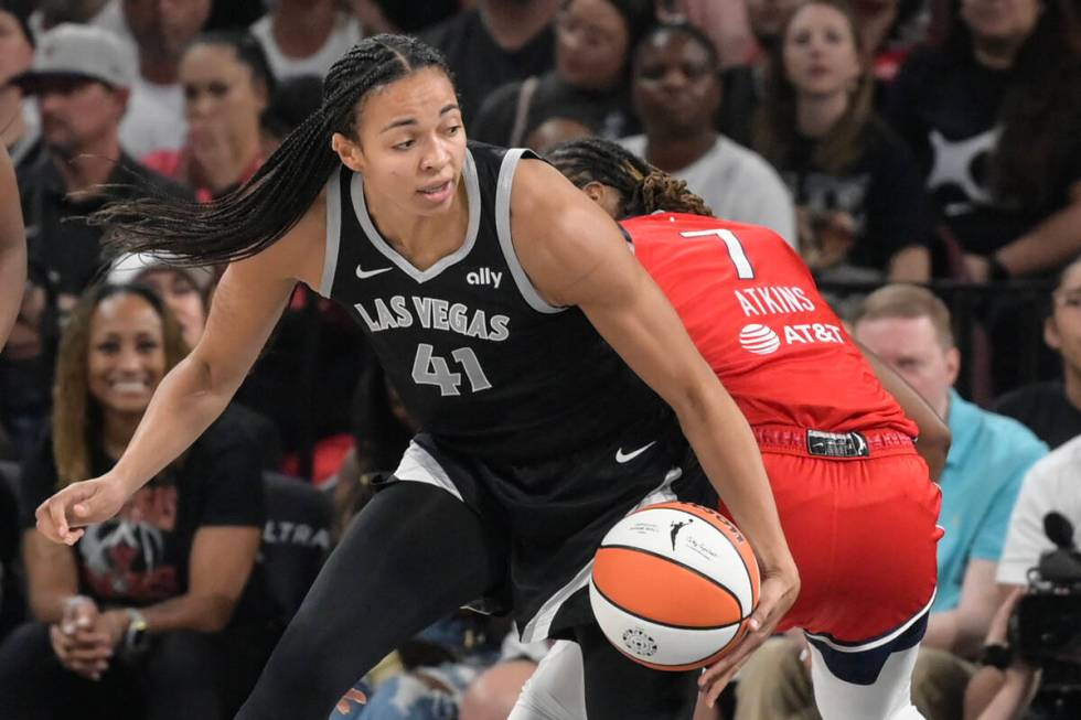 Las Vegas Aces center Kiah Stokes (41) drives around Washington Mystics guard Ariel Atkins (7) ...