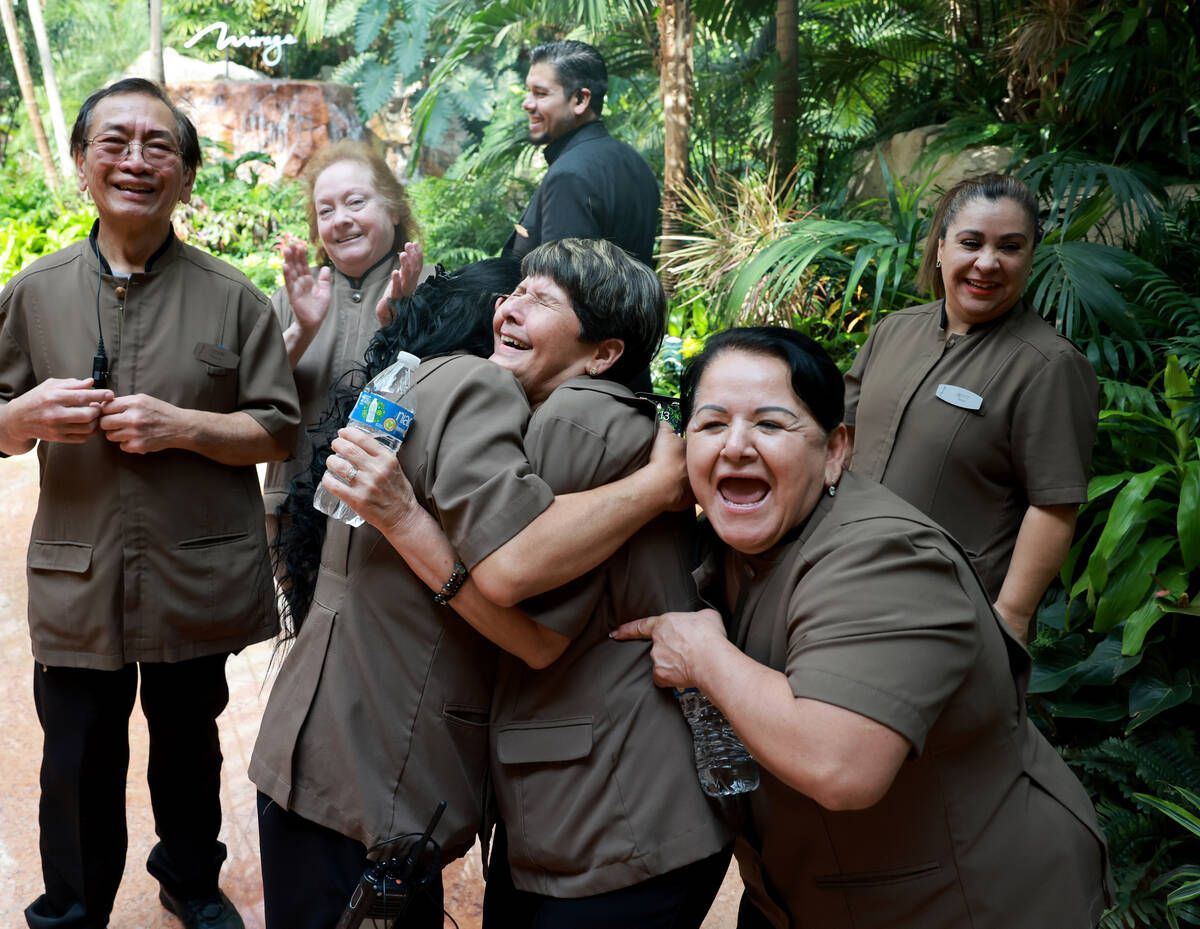 Casino porter Veronica Urbina, left, hugs Day 1 employees and fellow porters Lyceette Pagan and ...