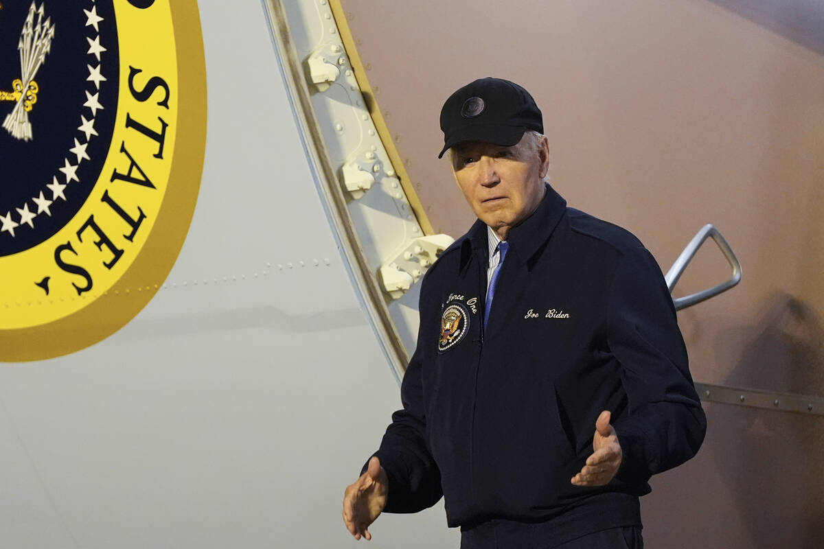 President Joe Biden walks down the steps of Air Force One at Dover Air Force Base in Delaware, ...