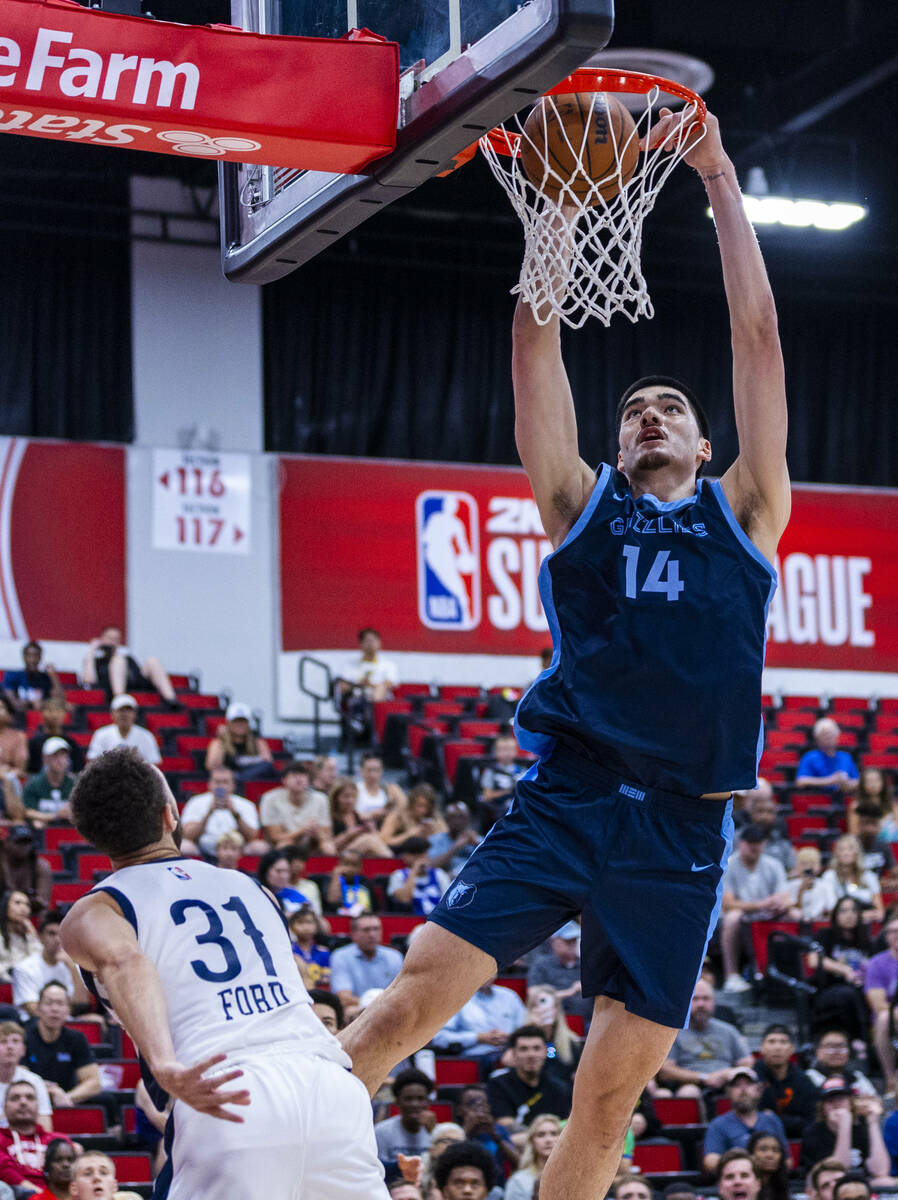 Memphis Grizzlies Center Zach Edey (14) dunks the ball as the New Orleans Pelicans guard Jordan ...