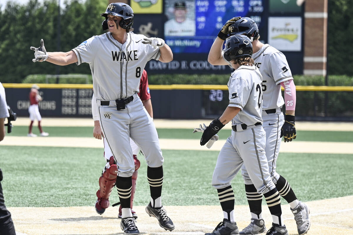 Wake Forest's Nick Kurtz (8) celebrates with Tommy Hawke and Brock Wilken after hitting a home ...