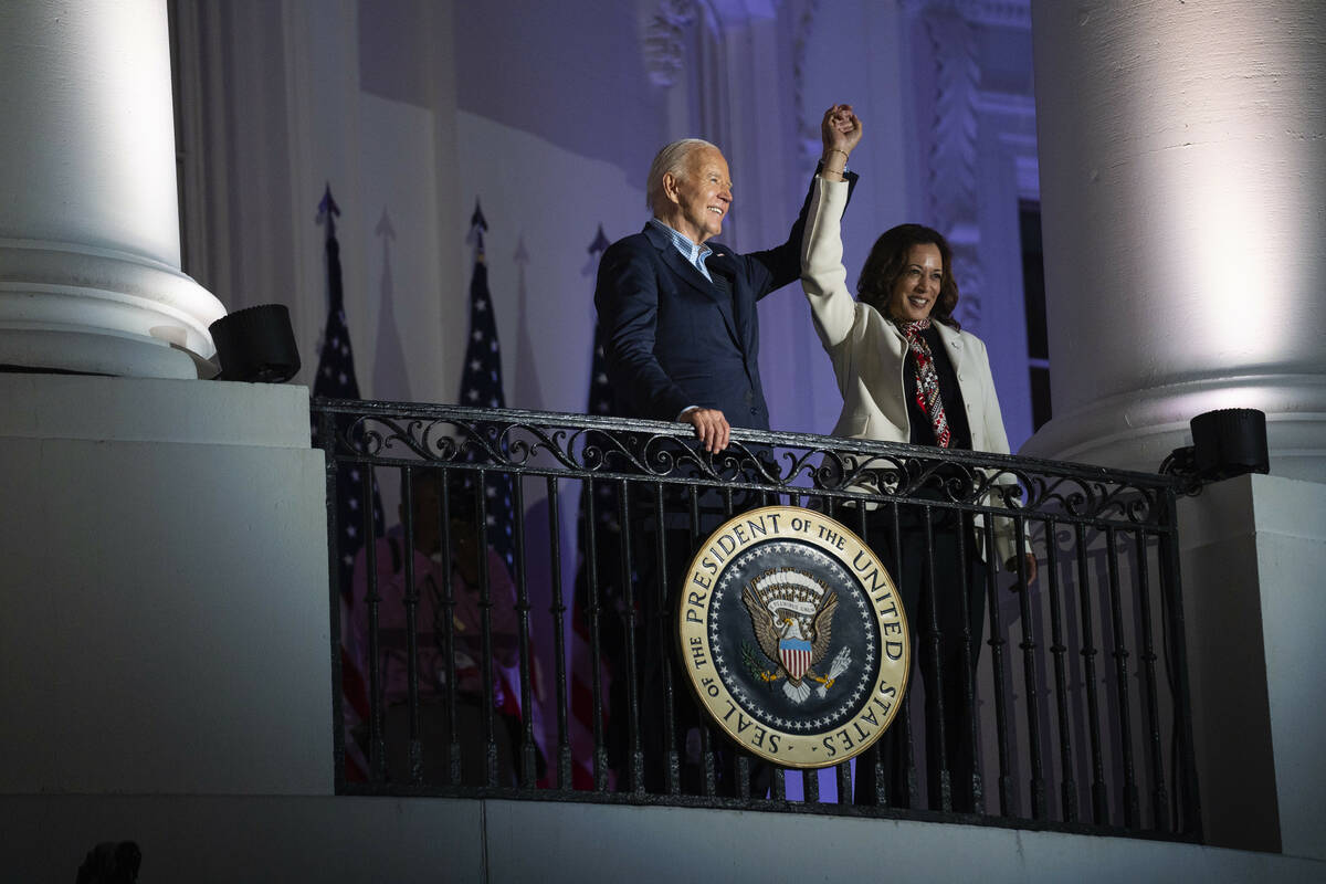 President Joe Biden raises the hand of Vice President Kamala Harris after viewing the Independe ...