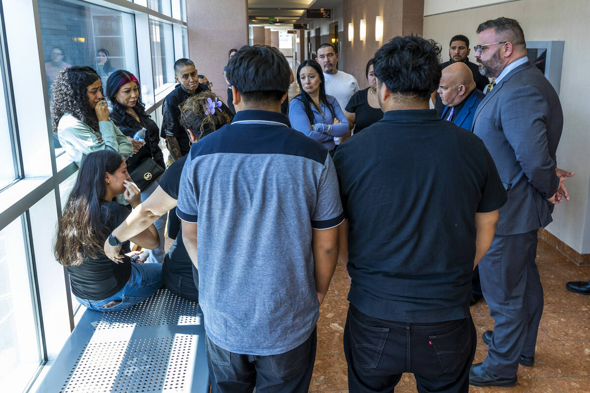 Family members are upset in the hallway as they listen to attorneys Eric Ferran and Charles Goo ...