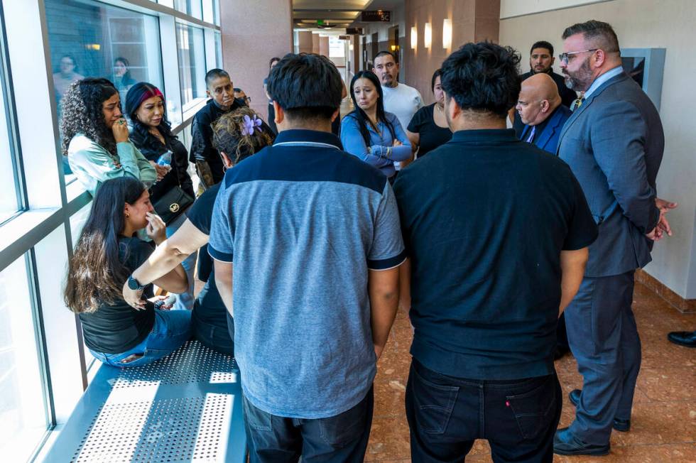 Family members are upset in the hallway as they listen to attorneys Eric Ferran and Charles Goo ...