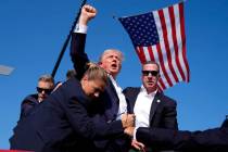 Republican presidential candidate former President Donald Trump raises his fist and calls out t ...