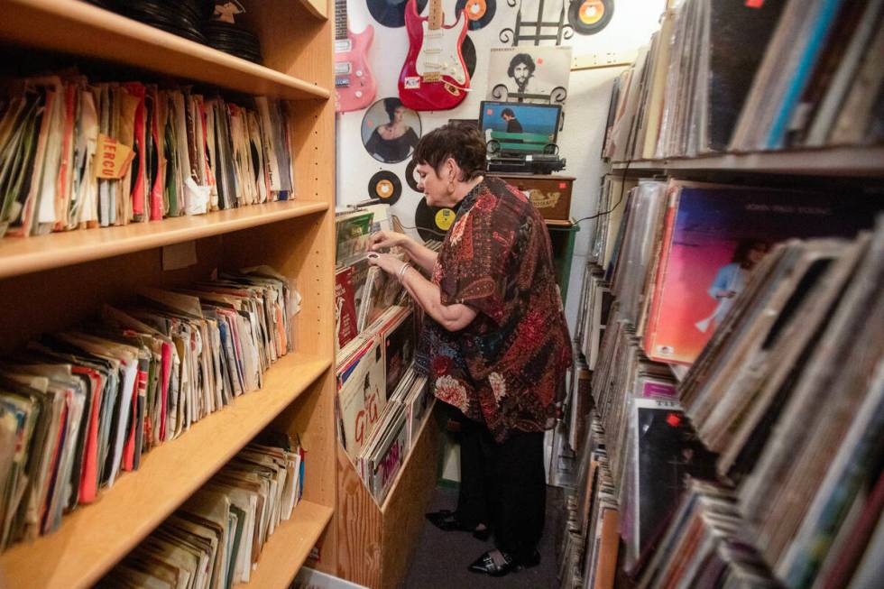 Co-owner Brenda Wright looks through vinyls at Sherman’s House of Antiques, Friday, July ...