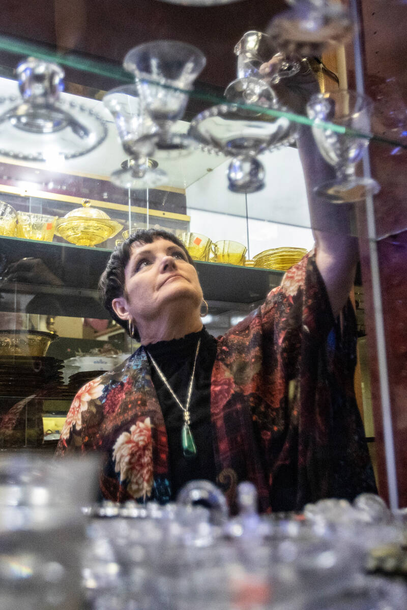 Co-owner Brenda Wright looks through glassware at Sherman’s House of Antiques, Friday, J ...