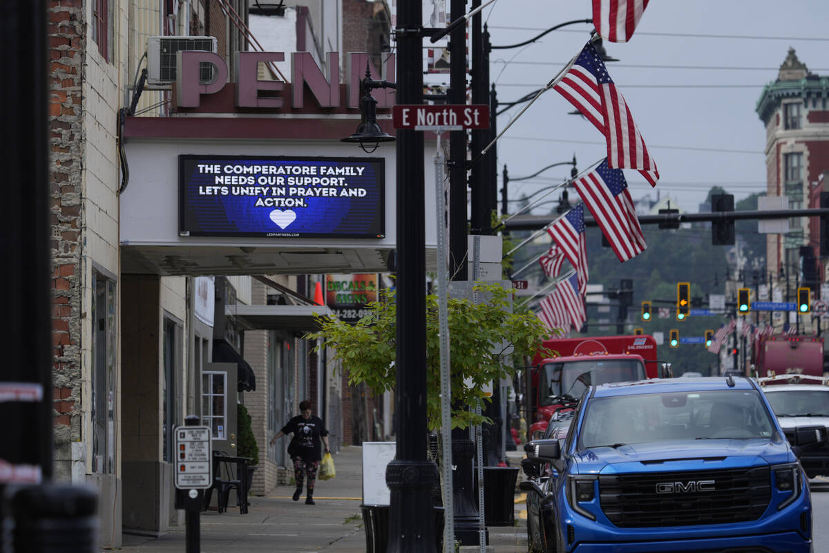 A memorial for Corey Comperatore is seen on a billboard at the Penn Theater in Butler, Pa., Thu ...