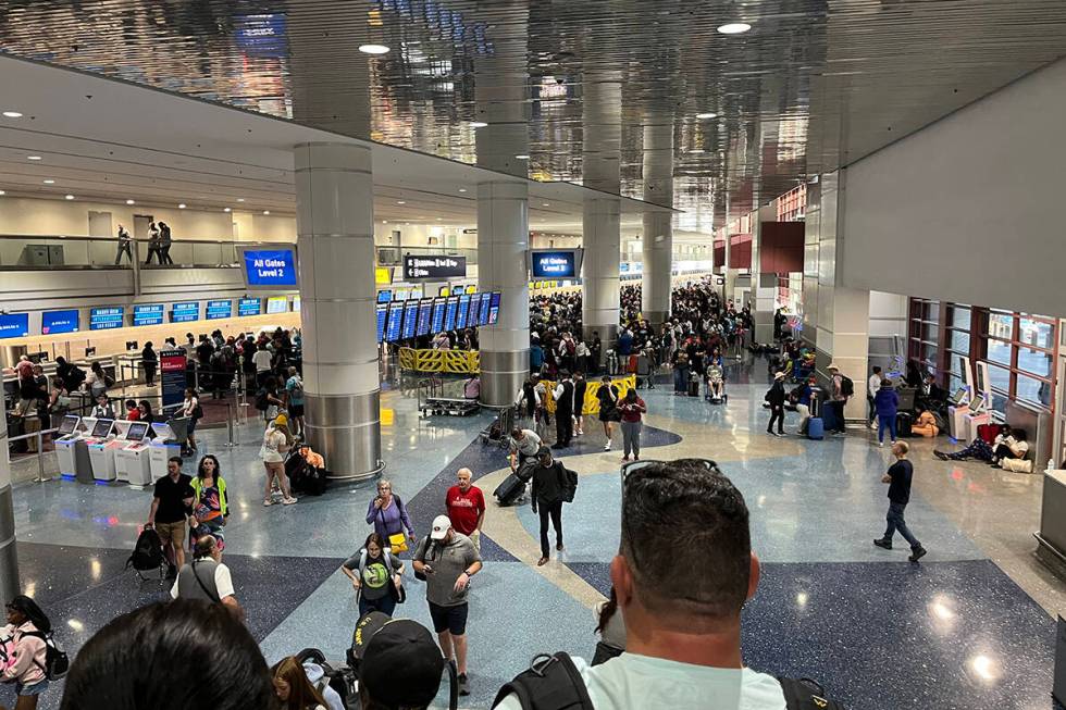Travelers deal with a global technology outage Friday, July 19. 2024, at Harry Reid Internation ...