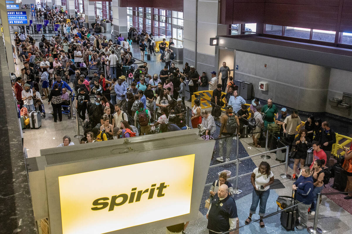 Passengers wait in line for the Spirit Airlines ticket desk at Harry Reid International Airport ...