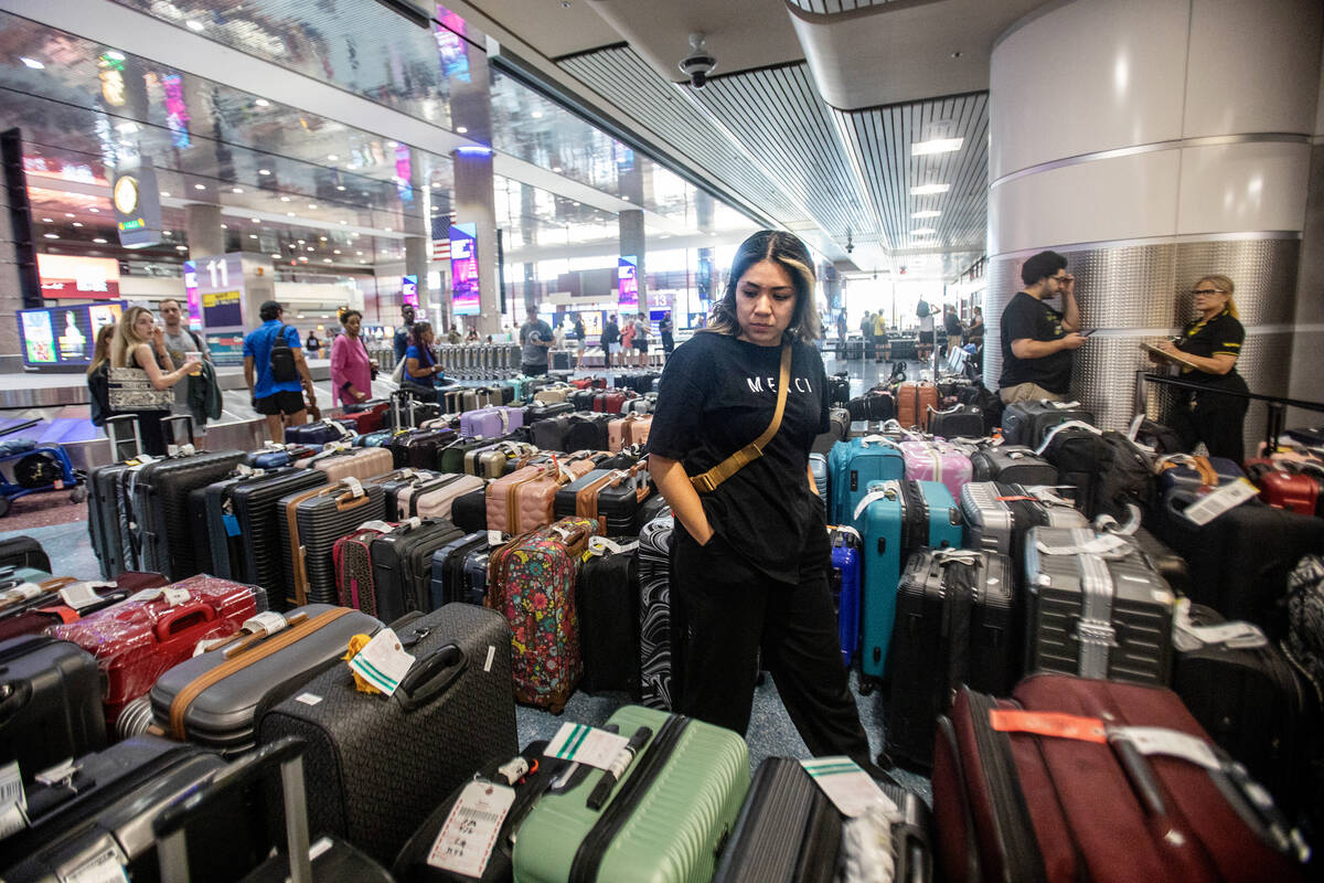 Passengers look for their baggage outside the Spirit Airlines Baggage Service office at Harry R ...